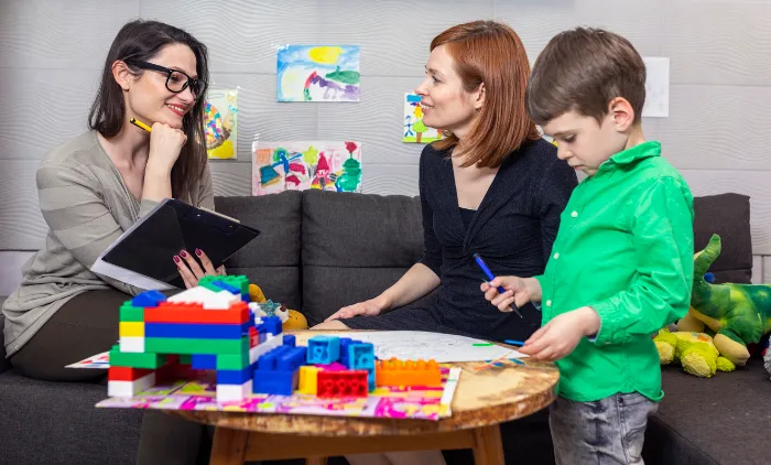 young boy doing play therapy.